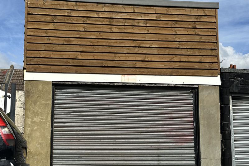 modern garage with horizontal timber cladding and rolle